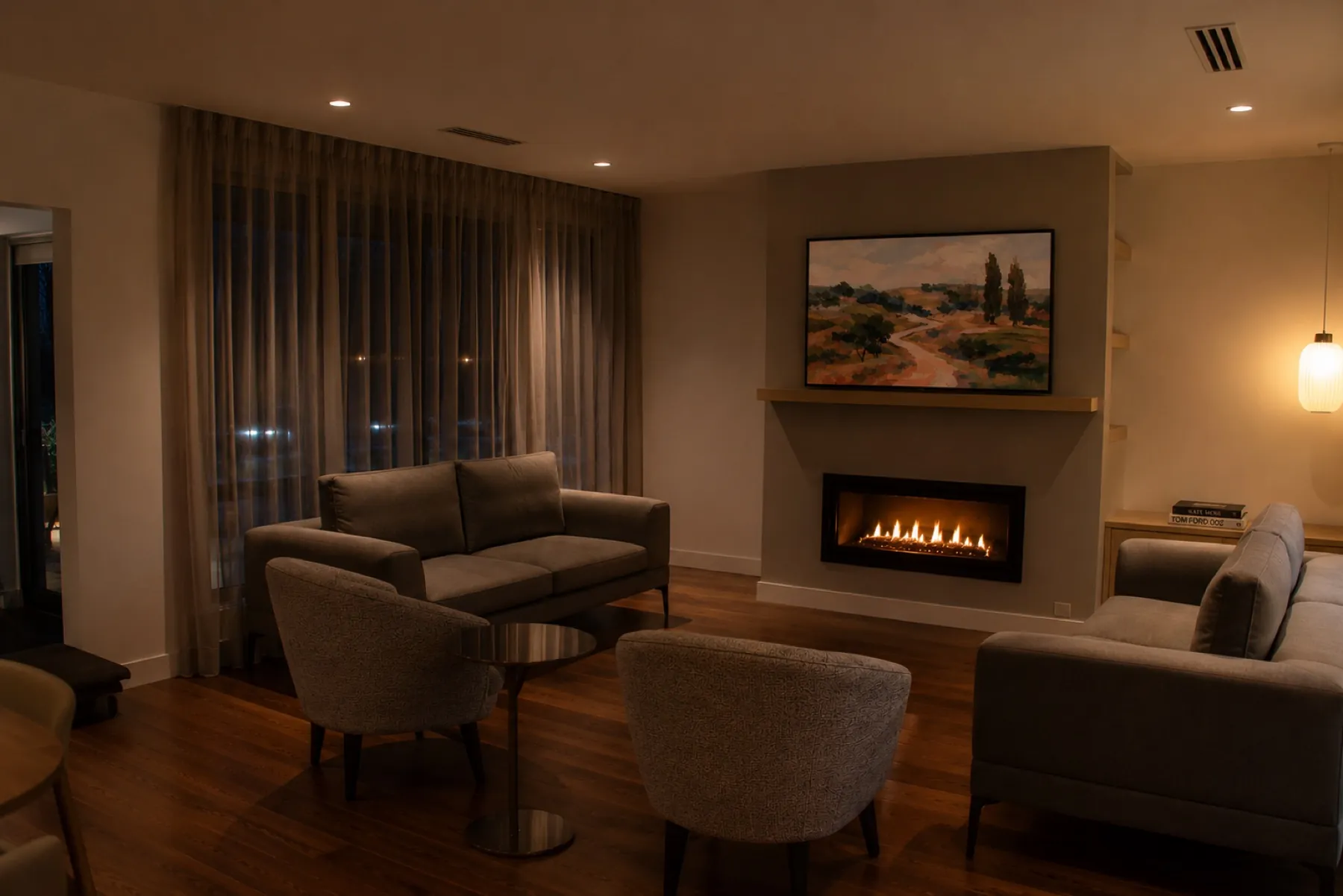 Living room at dusk with the gas fireplace lit